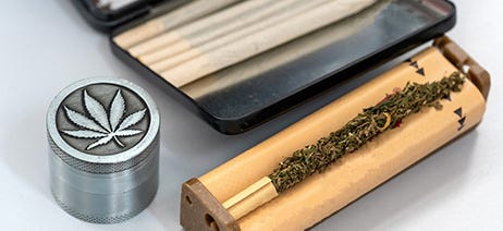 Joint roller with cannabis inside