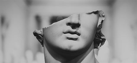Ancient marble statue with only half of a head