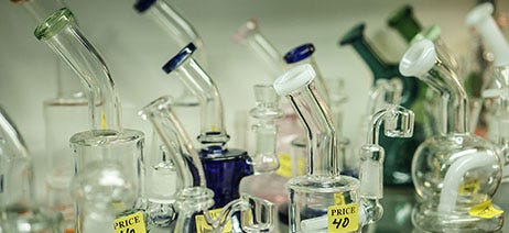 Variety of glass dab rigs on a store shelf