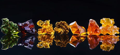 Row of cannabis concentrates on a black table