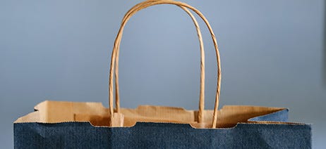 Top of a brown and blue paper shopping bag with handles