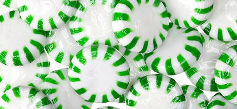 Closeup on a pile of green and white peppermints
