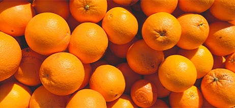 Pile of oranges laying in the sunshine
