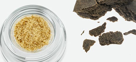 Hash in a white jar next to a brick of hash