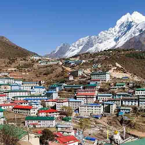 A colorful village in the mountains, in front of Mt Everest
