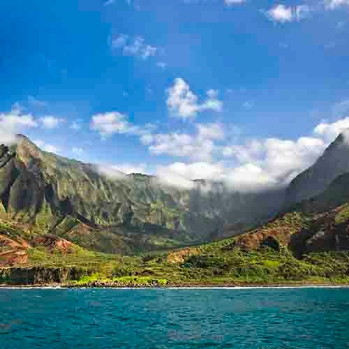 Green Hawaiian hills around the ocean