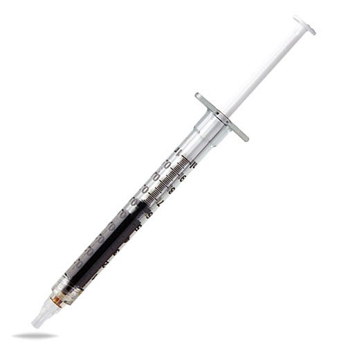 Filled RSO syringe on a cannabis leaf next to cannabis capsules