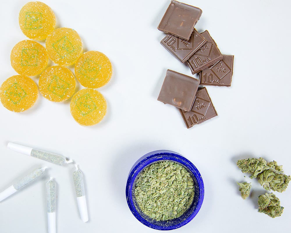 Gummies, chocolates, joints, kief on a table
