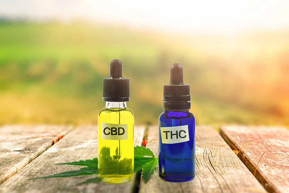 Two tincture bottles: one says THC and the other says CBD