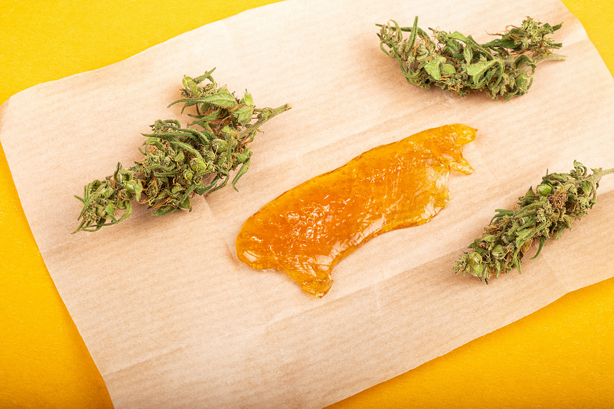 Marijuana flower and concentrate on rolling paper