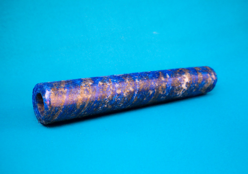 Cannabis one-hitter on a blue background