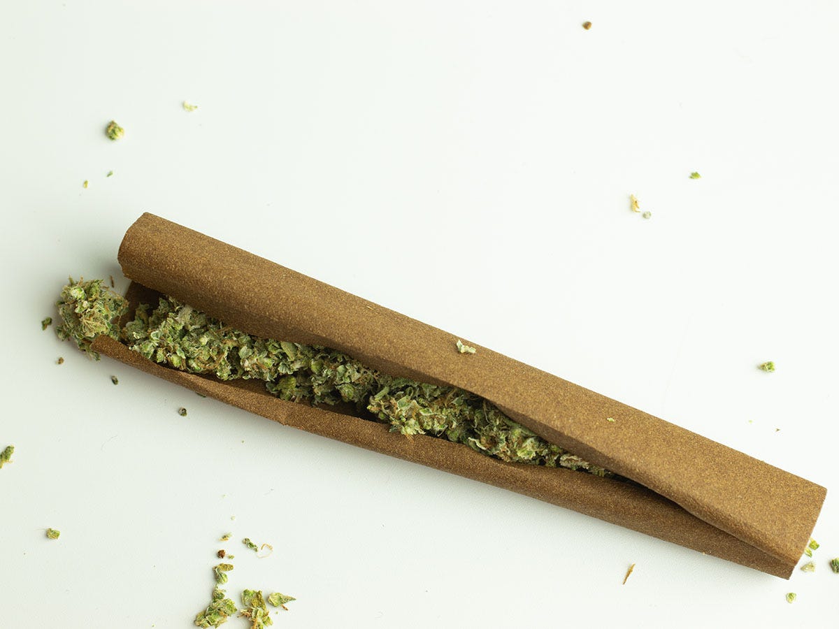 Cannabis flower spilling out of an open blunt wrap