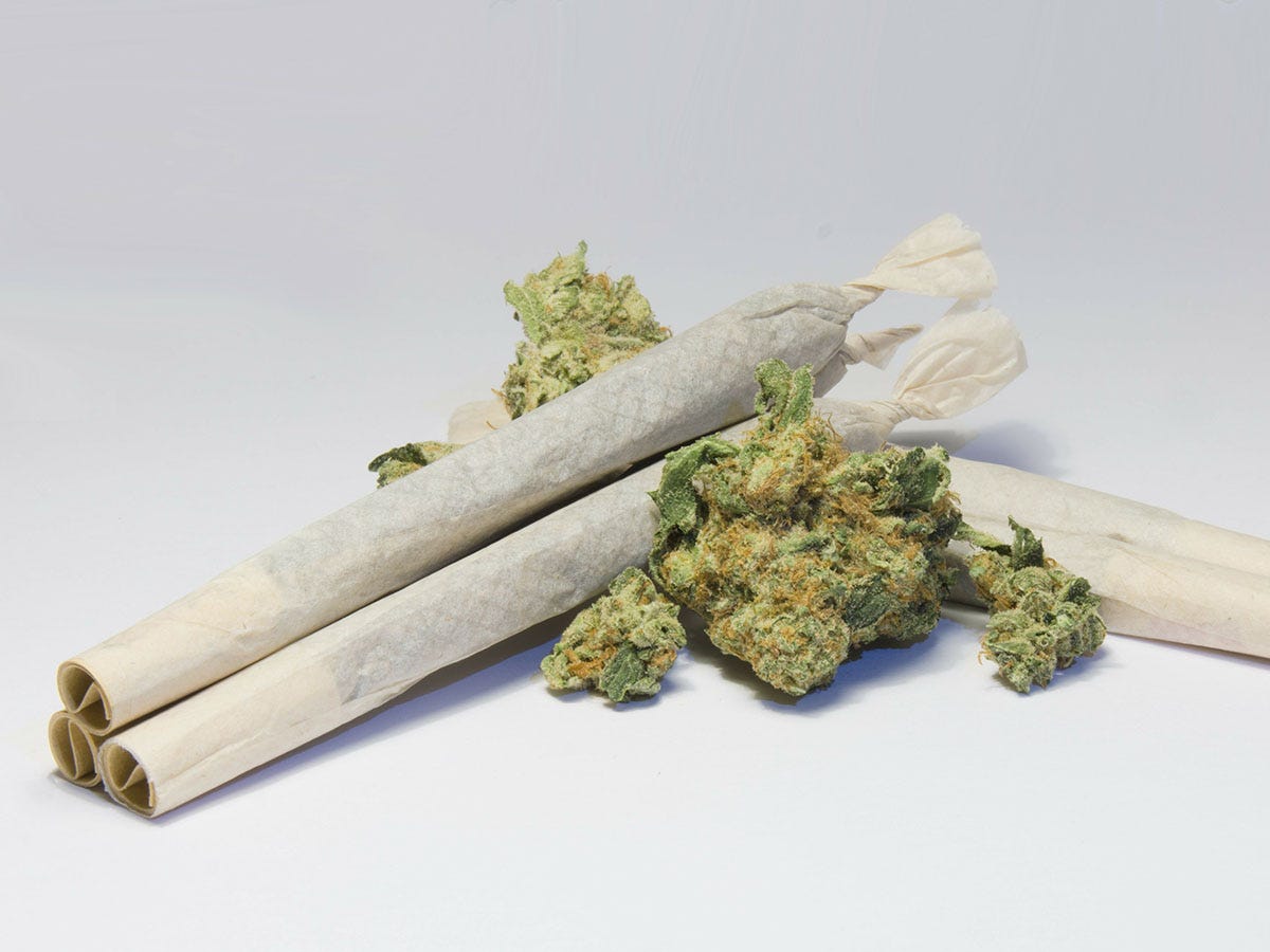Marijuana joints stacked up on several flower buds