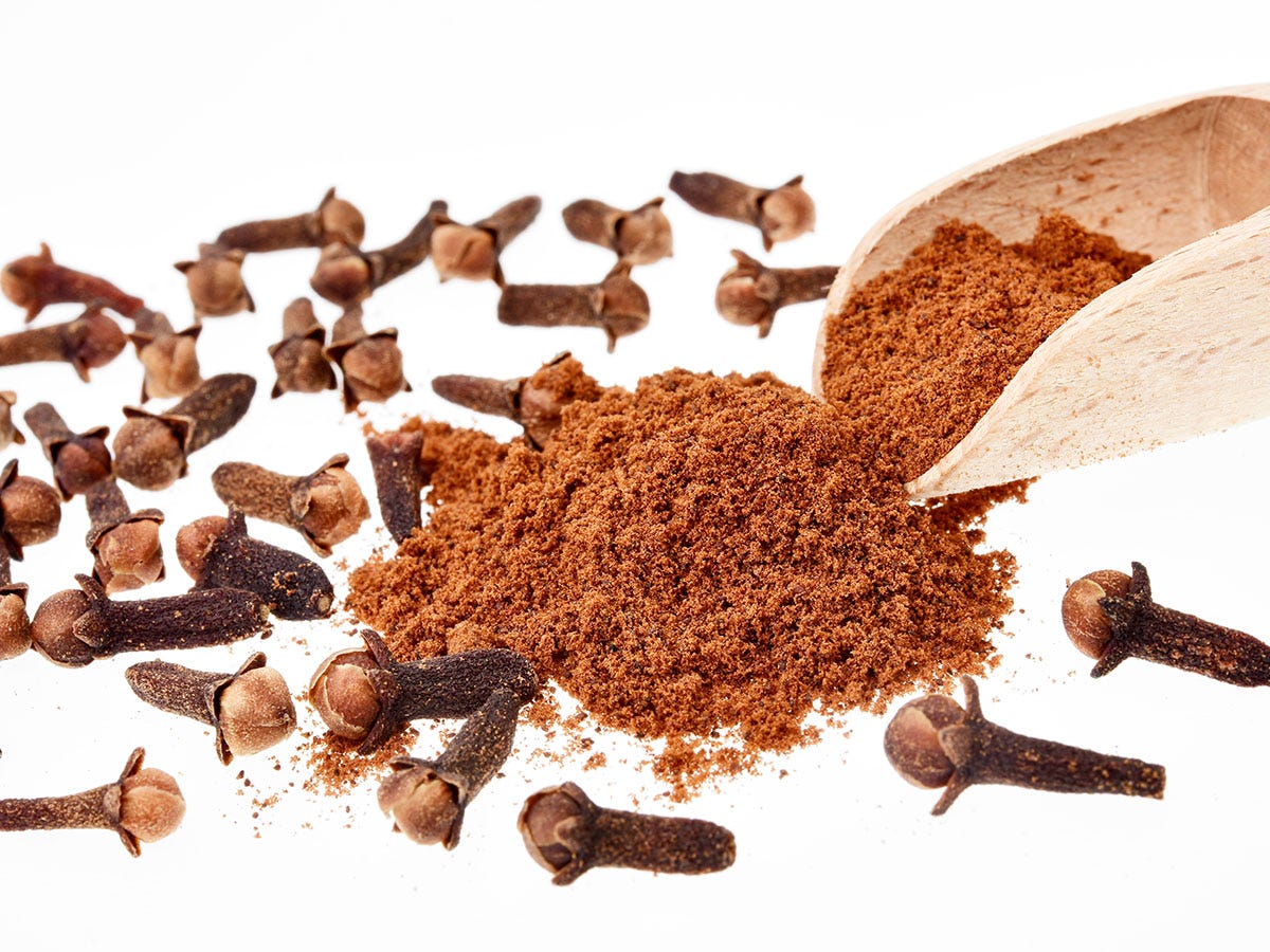 Cloves and cinnamon on a white background