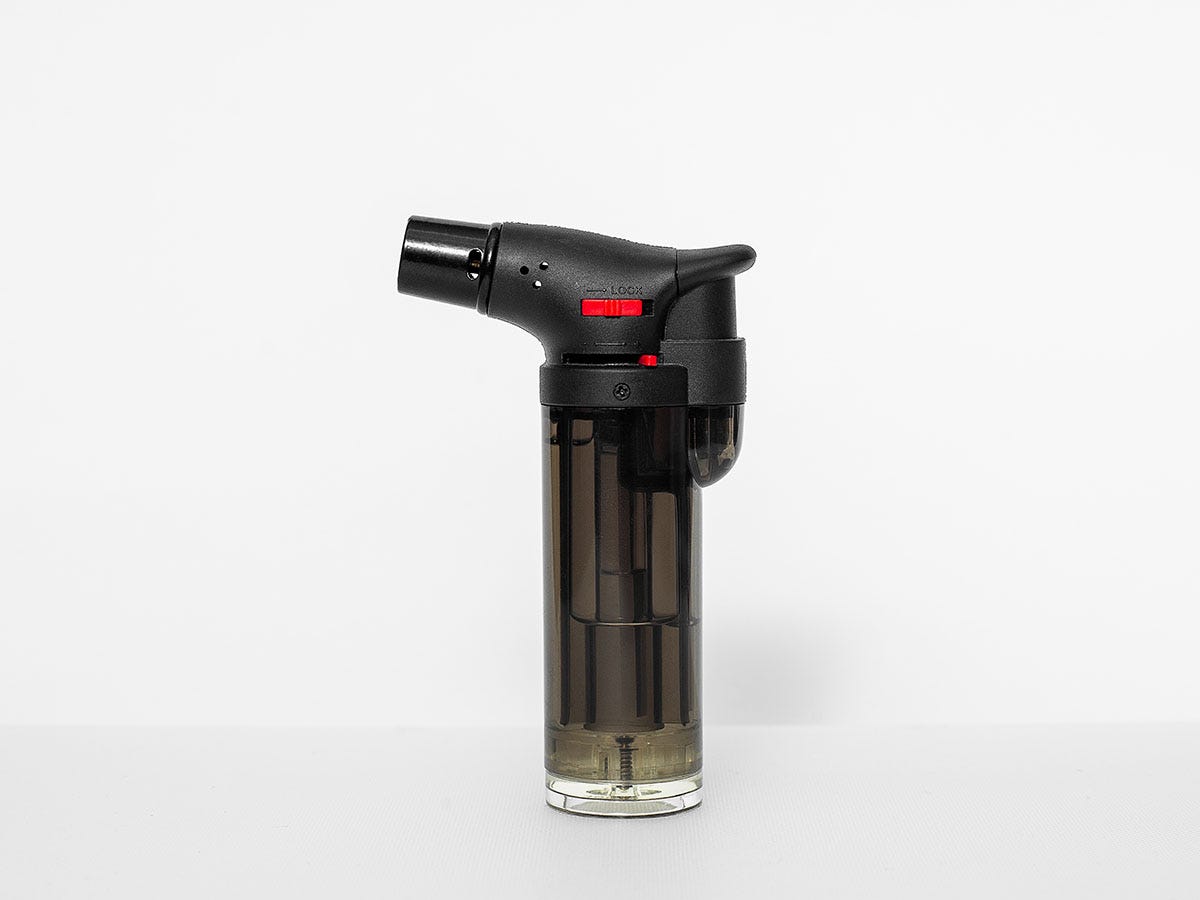 Black butane torch on a white background