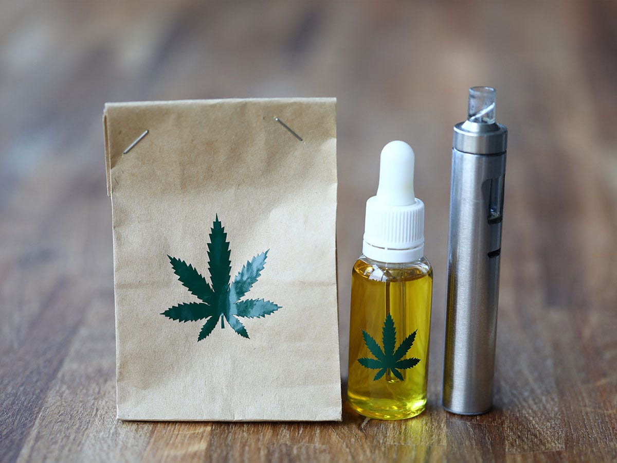 Brown paper bag, tincture bottle, and vape all with cannabis leaves on them