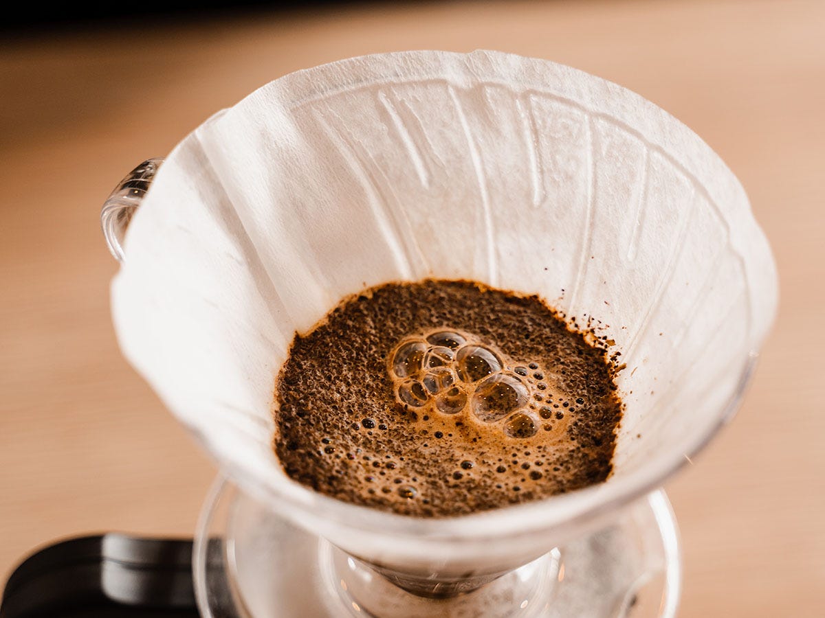 Cannabis hot chocolate being strained with a coffee filter