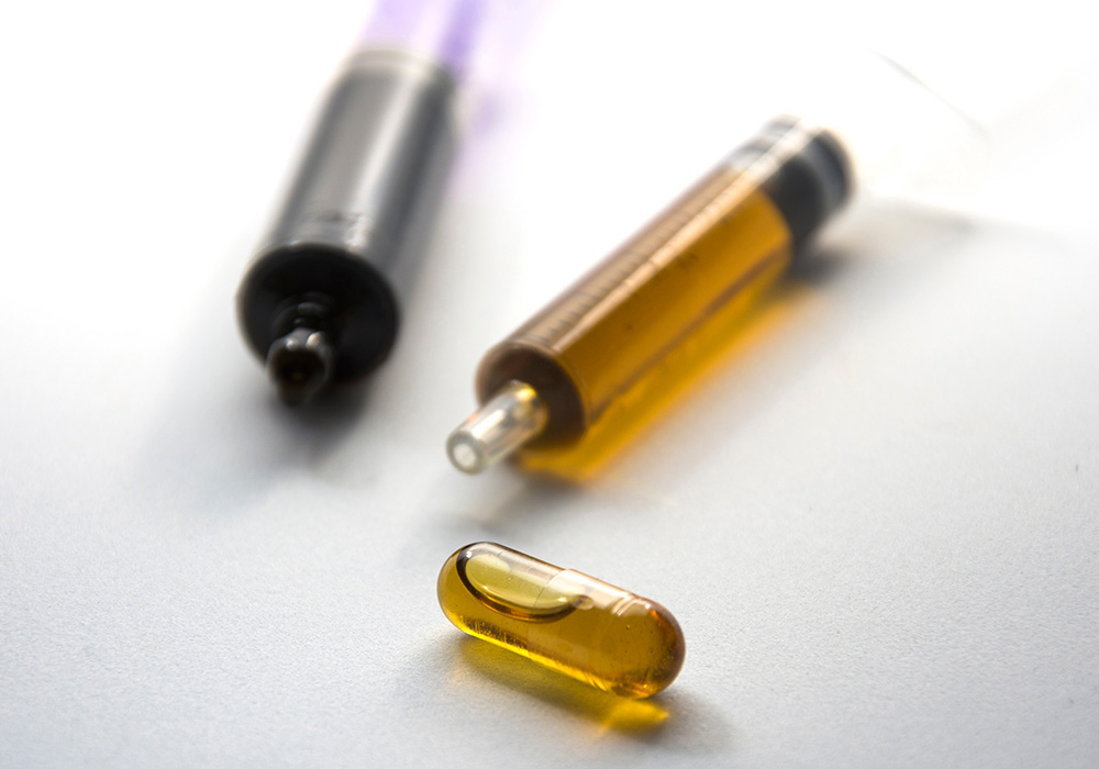 Two RSO syringes with an RSO-filled capsule