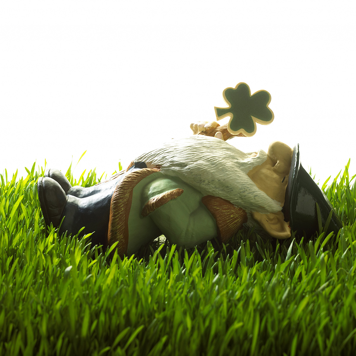 Leprechan sleeping on green grass