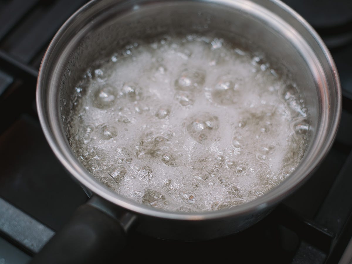 A saucepan contains a simmering mixture of THC syrup