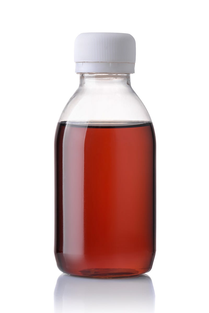 A clear glass jar holds amber-colored THC syrup