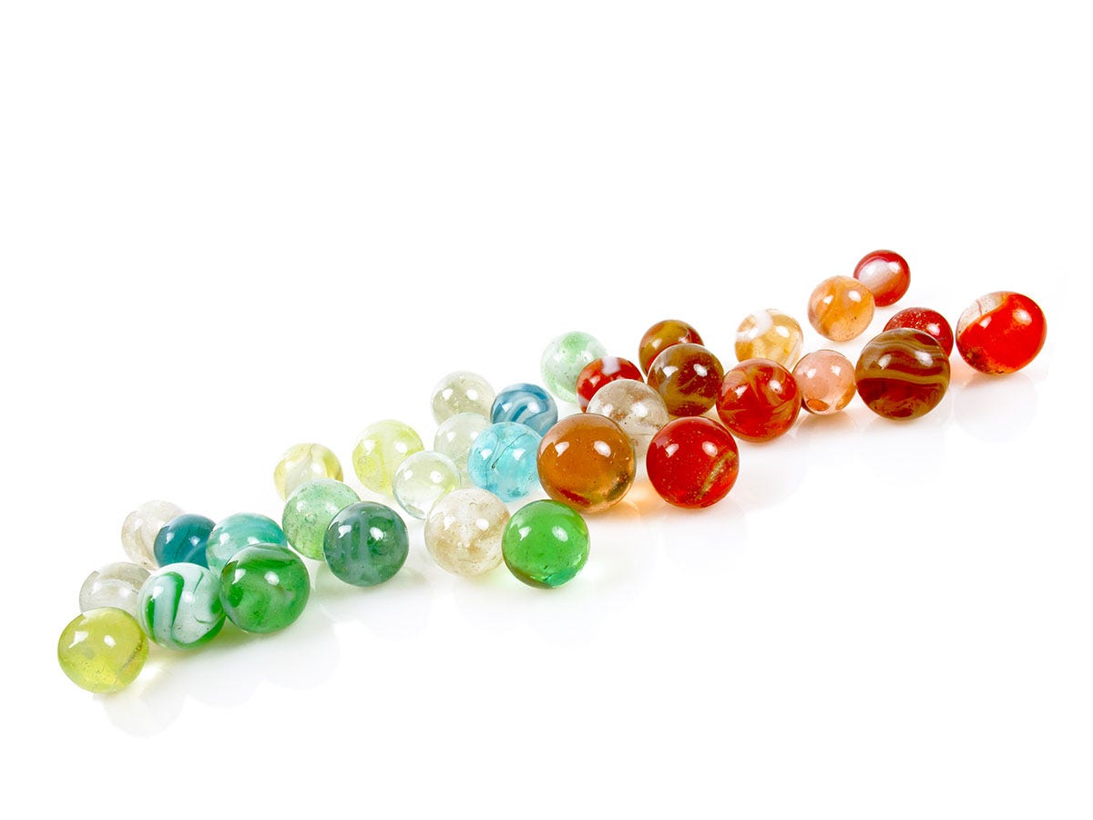 Colorful terp pearls grouped together in a line on a white background