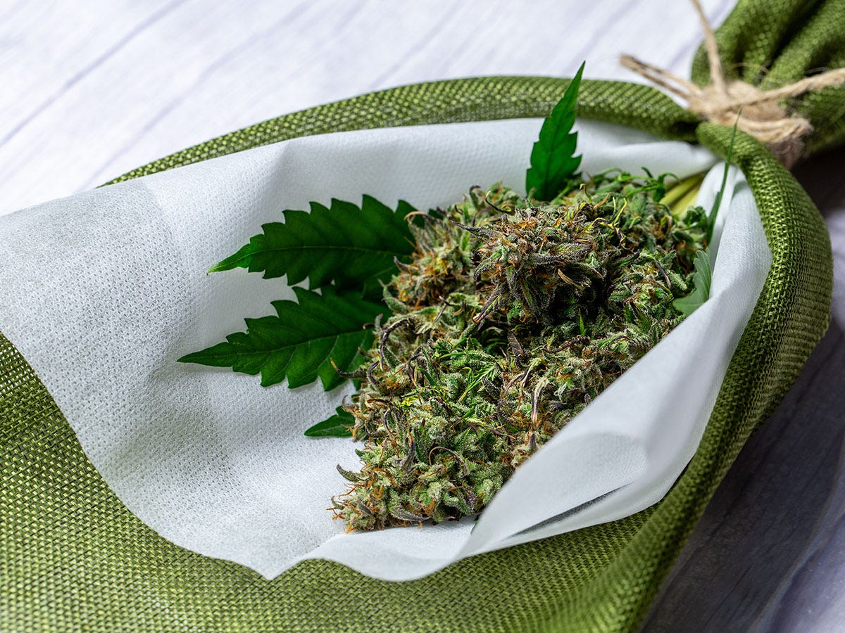 Cannabis flower wrapped in paper and string