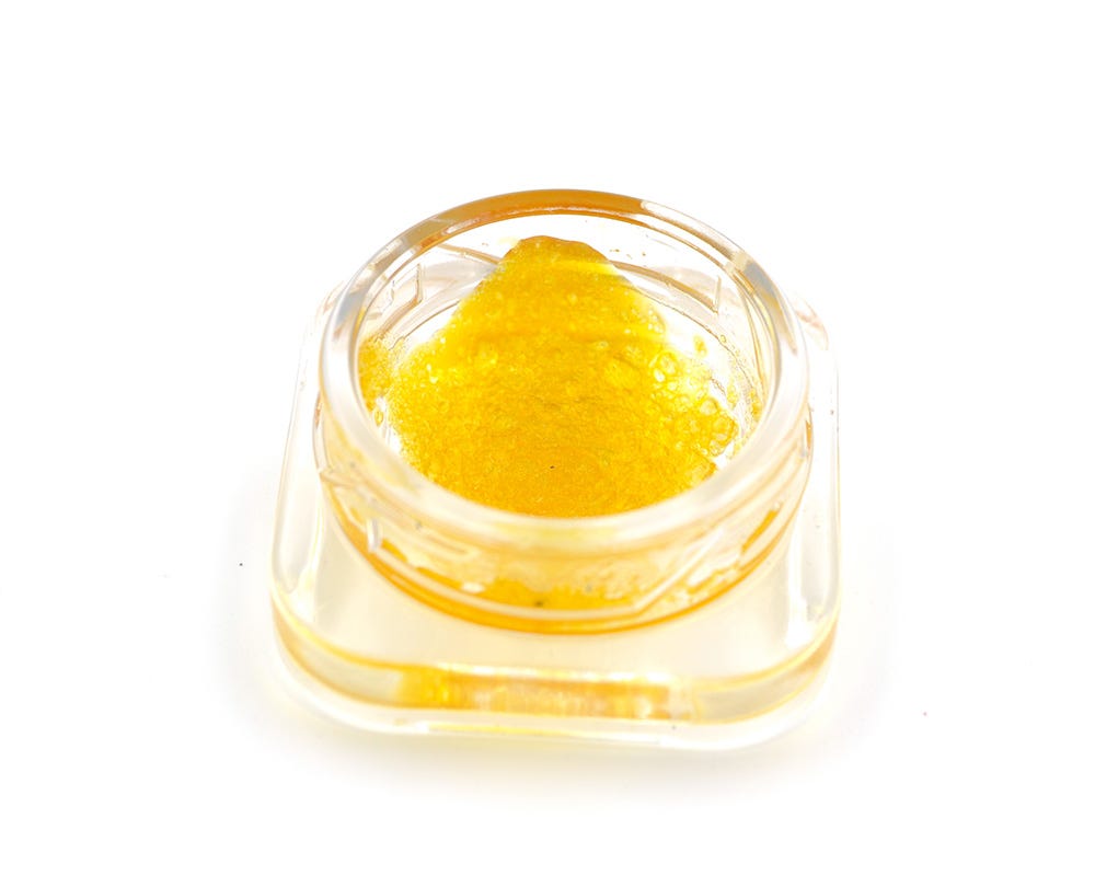Amber-colored concentrate in a clear jar