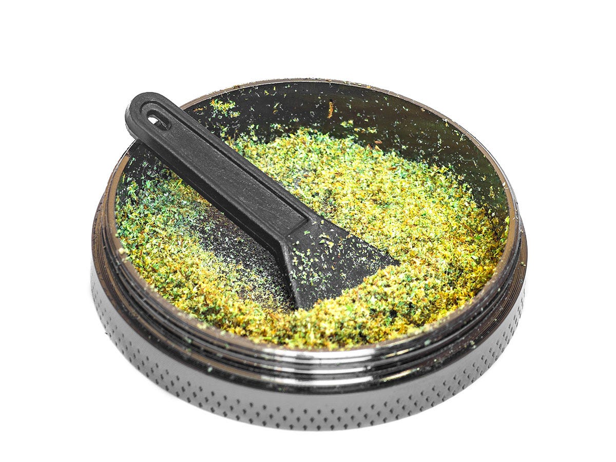 Kief catcher with bright green kief inside